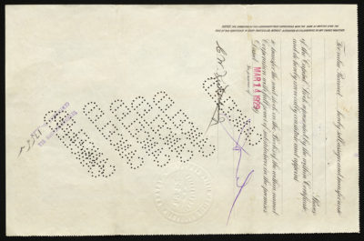 Backside shows various legal language including signatures and dates and cancel stamps punched out