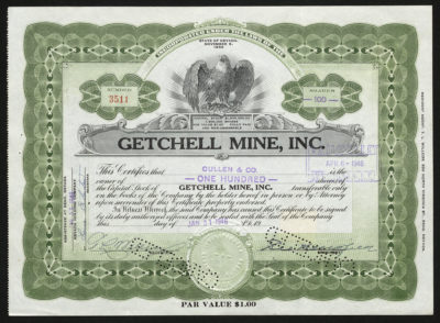 Certificate with black and green ink shows intricate borders and lettering, signatures, company seal, an eagle vignette and cancelled punched out