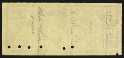 Back of certificate shows legal language, signatures, punched out holes, and stamps