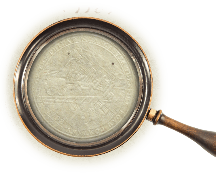 Magnifying glass over an embossed logo for the company